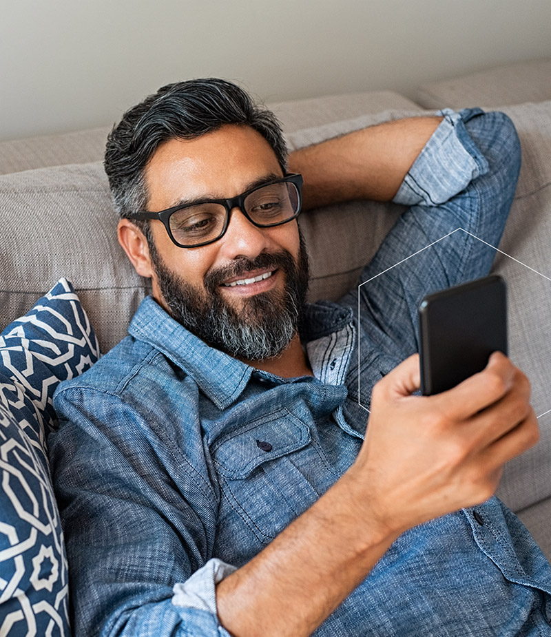 Man relaxing on couch looking at phone